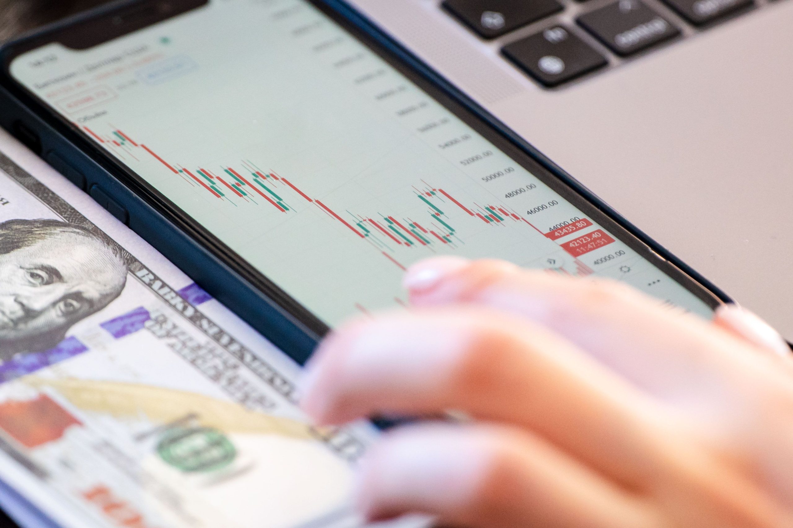 stock market ticker display,forex trading chart,busy trading floor,gold bars and US dollars,financial district skyline