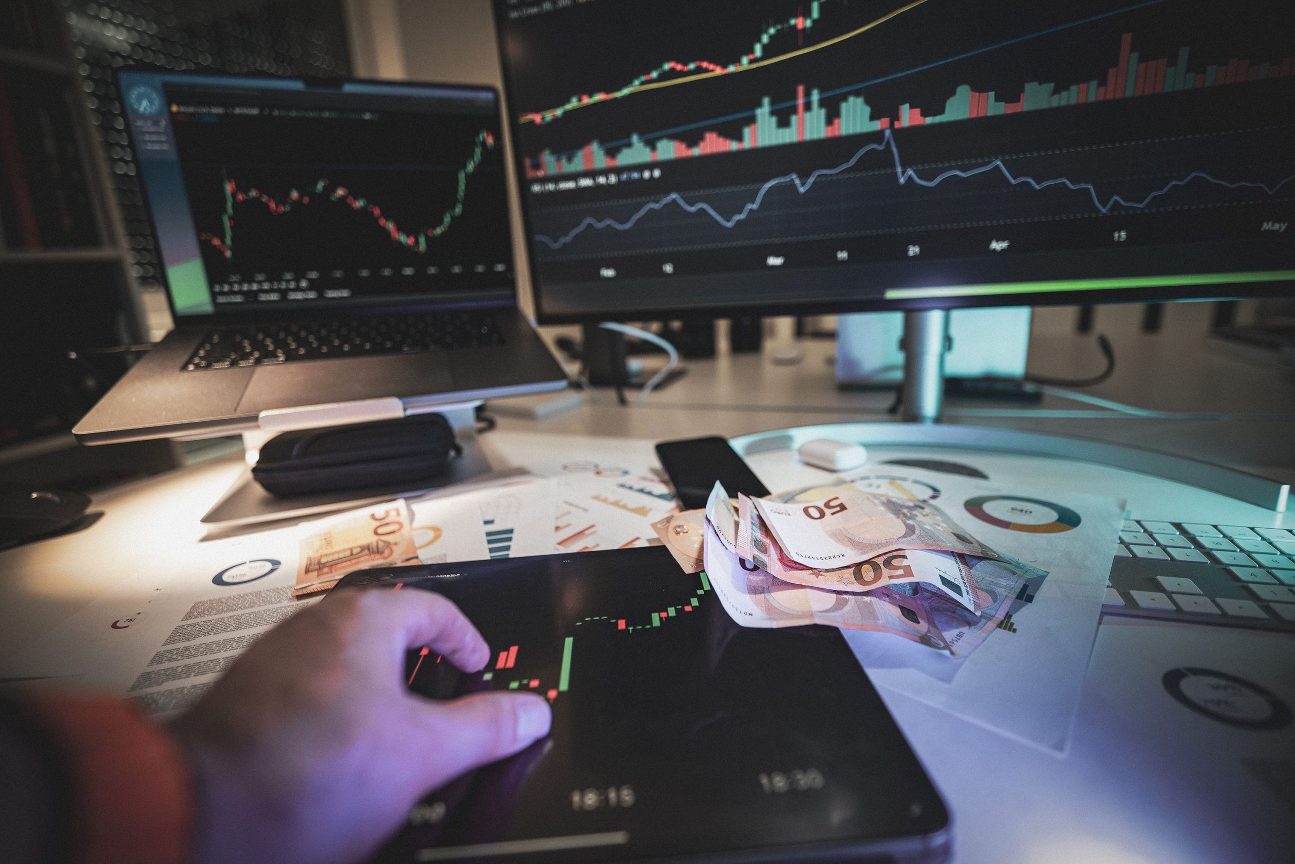 US dollar banknotes and forex chart,stock market trading screen with candlesticks,trader workstation with multiple monitors,Wall Street bull statue,currency exchange board